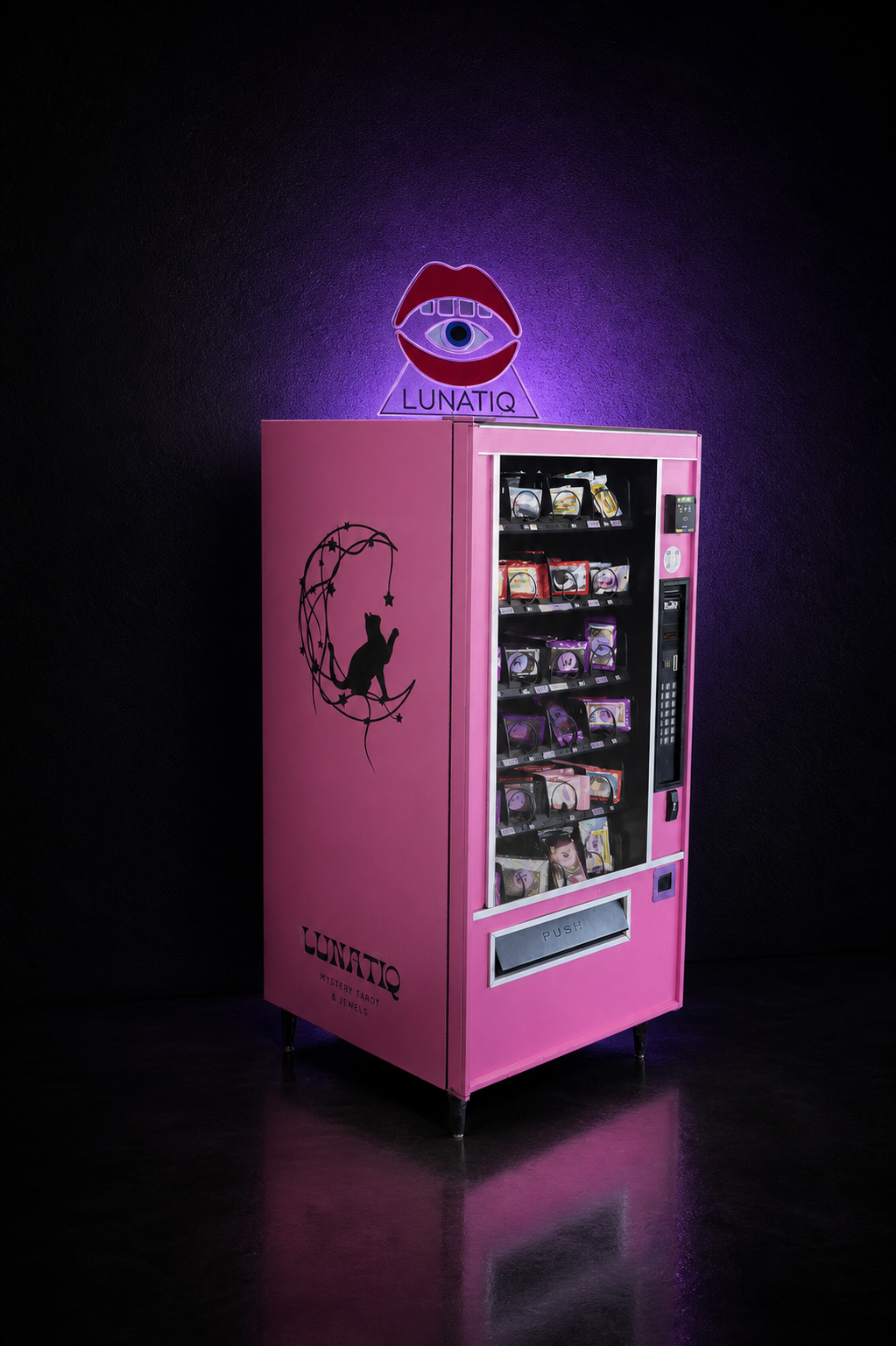 The pink Lunatiq vending machine illuminated in a dark purple-lit space