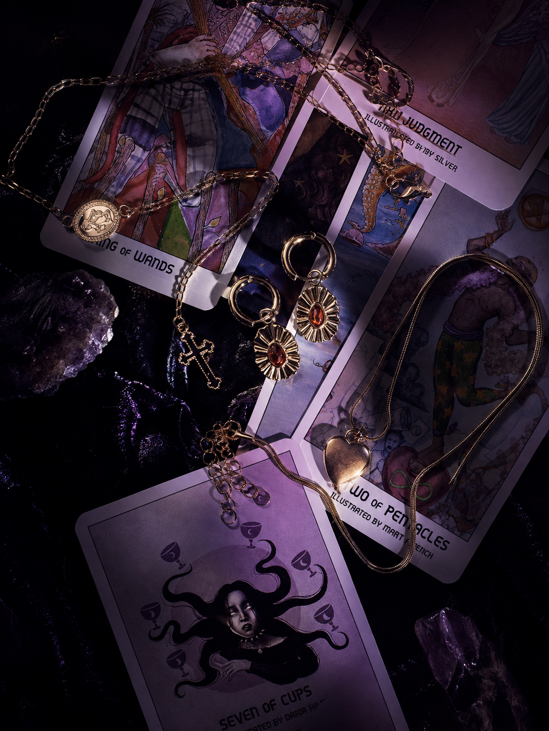 Lunatiq jewelry arranged across tarot cards